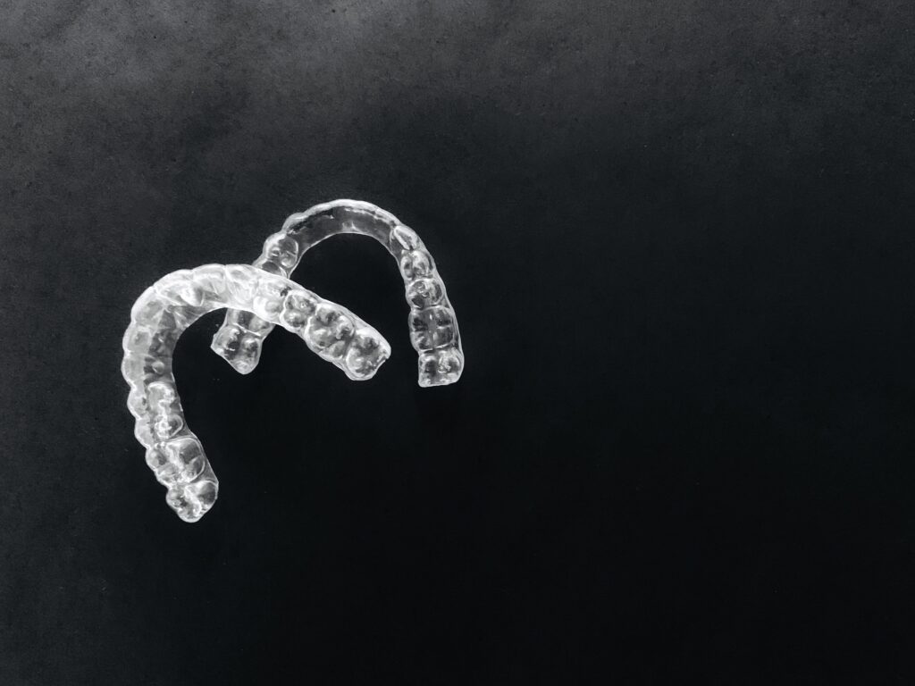 invisalign retainers on a black background braces 2021 09 02 16 18 21 utc 1