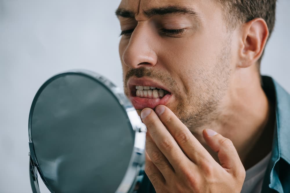 close up view of young man with tooth pain looking 2022 02 03 11 53 30 utc 1