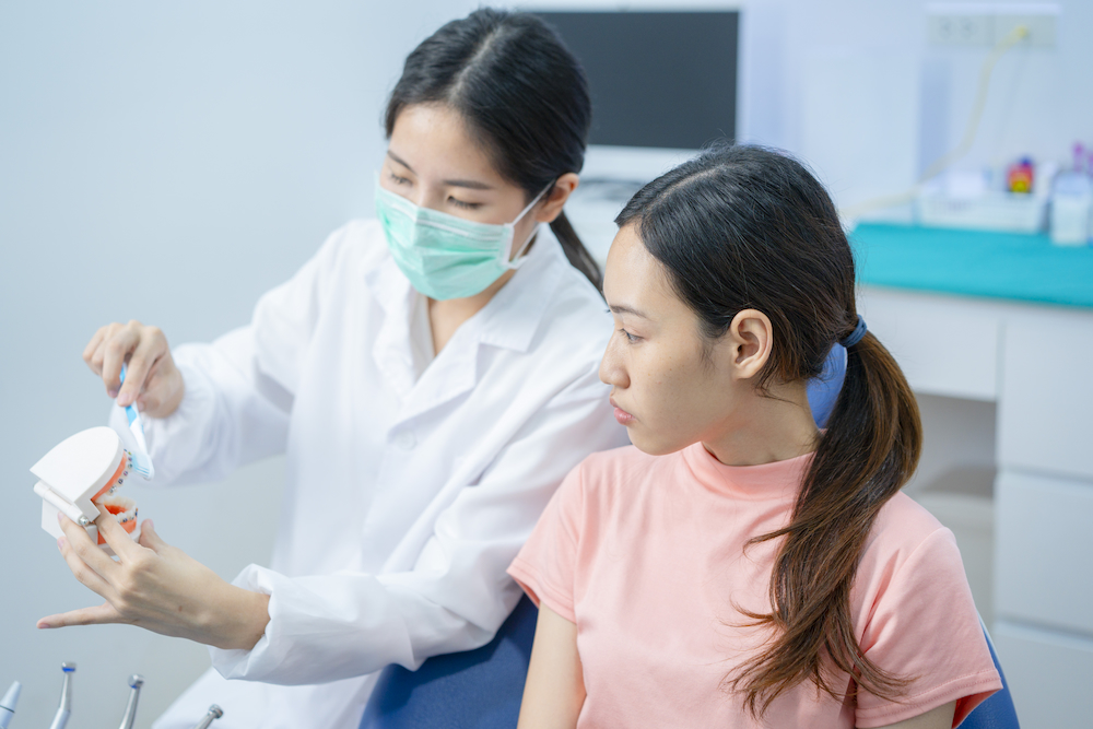 asian young woman listen to female dentist explain 2021 12 09 17 03 34 utc 1